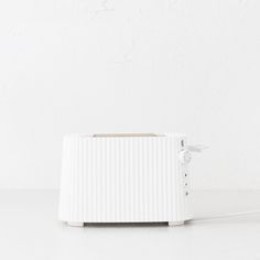 a white toaster sitting on top of a counter