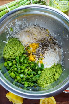 the ingredients for this dish are mixed together in a large metal bowl on top of a wooden table