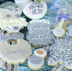 baby shower cookies are arranged on a glass plate