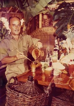 a man sitting at a table with some drinks in front of him