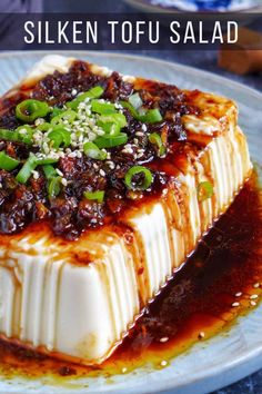 there is a dessert on the plate with sauce and green onions in it that says silken tofu salad