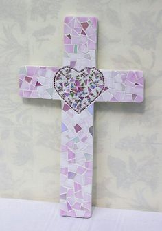 a decorative cross with a heart on it