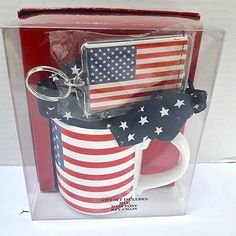 a red, white and blue mug with an american flag keychain in it