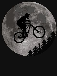 a man riding a bike in front of a full moon with trees on the ground