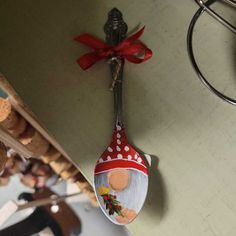 a red and white spoon hanging from a wall