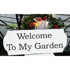 a welcome to my garden sign with flowers