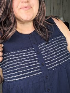 Introducing the Rina Smocked Detail Button Front Tank- the cutest tank you'll find this summer! With functional buttons for double duty wear (open it up and treat it like a vest!) and smocking on the bust for a flattering fit. Comes in classic colors for easy styling. Perfect bra coverage and a great flow at the belly. Double the functionality, double the fun! Fit: true to size, between sizes can size down. Michele is an apple shaped size 20 wearing her typical 2x with a little extra room. Fabric: 100% rayon Sleeveless Smocked Top For Beach, Summer Sleeveless Smock Top, Beach Tank Top With Buttons, Sleeveless Smocked Cotton Top, Casual Button-up Top With Smocked Bodice, Casual Tank Top With Buttons For Daywear, Casual Buttoned Tank Top For Daywear, Layering Hoodies, Apple Shaped