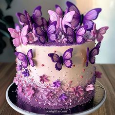 there is a cake with purple butterflies on it