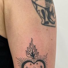 a woman's arm with a tattoo on it and a heart in the middle