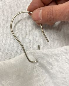 a person is stitching through some fabric with scissors