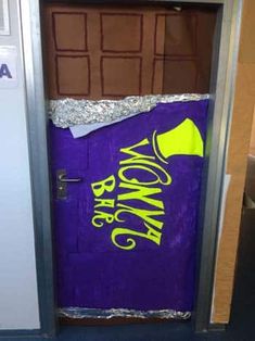 a purple door with yellow writing on it