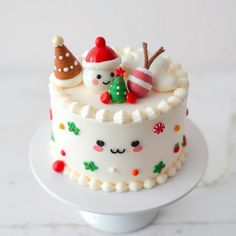 a cake decorated with white frosting and christmas decorations