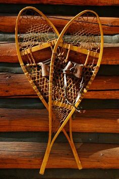 a wooden wall hanging with two baskets in the shape of a heart on it's side