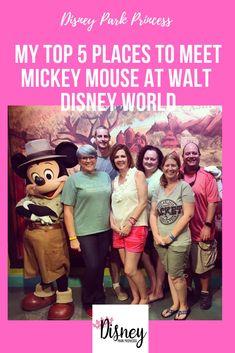 some people are posing for a photo with mickey mouse at walt world in disney park