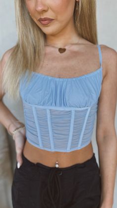 A light blue mesh corset top is a fitted garment that accentuates the curves of the upper body. It typically has a clasp back and a structured front with boning to provide support and shape. The light blue color adds a soft and feminine touch, making it a perfect choice for a special occasion or a stylish outfit. Custom Outfits, Soft And Feminine, Mesh Corset, Stylish Outfit, Blue Skies, Light Blue Color, Corset Top, Upper Body, Custom Clothes