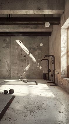 an empty room with some balls on the floor and a rocket in the air above it