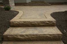 stone steps lead up to the front door of a house