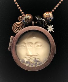 "This piece felt like making a collage. Different pieces came together to make a unique necklace. The pendant is a locket with a Double moon face anchored to the back of the locket. I have added some dried lavender. The beauty of this is that the locket opens and you can remove or replace the lavender with something meaningful to you as long as it fits inside. All the metals are antiqued copper with the exception of the crystal star. I have also added three glass beads and a copper spiral that I Making A Collage, Moon Locket, Antique Locket, Moon Face, Dragonfly Necklace, Semi Precious Gems, Crafts Jewelry, Jewellery Ideas, Crystal Stars