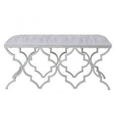 a white bench with an intricate design on the top and bottom, sitting against a white background