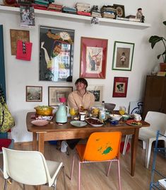 a woman sitting at a table with food on it