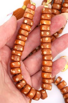 A rich, nutty shade of brown, these beads remind us of caramel and butterscotch. These earthy neutral bone beads are made in India, from water buffalo and cow bone (cruelty-free) that has been dyed in a delicious shade of brown. Circular bullseye patterns are carved into the surface of each bead. ✨The Magic is in the Details✨Approx. Bead Size: 12x6mmApprox. Hole Size: 2mmApprox. Number of beads Per Strand: 33Strand Length: 8.5"Color: Butterscotch Brown✨📿✨📿✨📿✨Curious to know about the source o Artisan Brown Spacer Beads, Brown 8mm Beads For Jewelry Making, Traditional Brown Beads For Gifts, Traditional Brown Beads For Gift, Brown Polished Beads For Jewelry Making, Artisan Brown Beads For Gifts, Traditional Brown 8mm Beaded Jewelry, Brown Jewelry With 8mm Oval Beads, Traditional Brown Jewelry With 8mm Beads