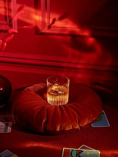 a glass sitting on top of a red cushion