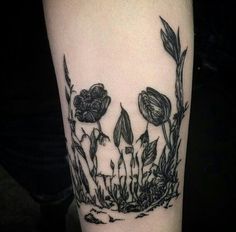 a black and white photo of flowers on the arm