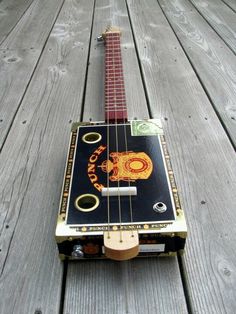 a small guitar sitting on top of a wooden floor