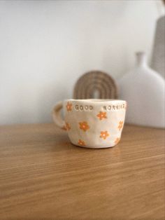 a cup sitting on top of a wooden table