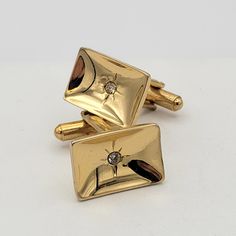 Vintage 1960s Gold Tone Concave Rectangle Cuff Links with Atomic Starbursts & Rhinestones  This vintage set of cuff links is sure to get noticed.  The gold-tone cuff links are rectangular in shape & concave.  The cuff links have rhinestones in the center that are set in an atomic starburst engraving.  This set is in excellent vintage condition with very little wear. Dimensions:  3/4" x 1/2" Markings:  None Condition:  Excellent - very little wear All of my shop items are pre-owned vintage.  All pieces should be expected to have some vintage wear unless otherwise stated.   Great for the vintage & costume jewelry lover!  Be sure to check out our other vintage jewelry listings! Looking for something that isn't listed in my shop? Send me a message! I have thousands of pieces in stock. Accessories Formal, Atomic Starburst, Tie Tack, Tie Clips, Tie Accessories, Suit And Tie, Vintage Costume Jewelry, Vintage Wear, Cuff Links