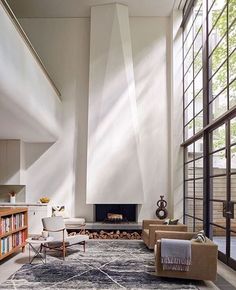 a living room filled with furniture and a fire place in the middle of a room