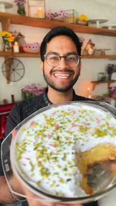 a man holding a plate with a cake on it