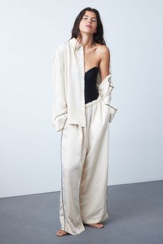 Pajama shirt and pants in softly draped satin. Shirt with a collar  concealed buttons at front  and yoke at back with box pleat. Open chest pocket and long sleeves with wide cuffs. Wide-cut pants with an elasticized drawstring waistband and diagonal side pockets. Satin Pyjamas, Wide Trousers, Satin Pajamas, Satin Shirt, Women Nightwear, Wide Cuff, Pajama Shirt, Shirt And Pants, Y2k Fashion