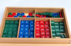 a wooden box filled with lots of different colored blocks and numbers on top of each other