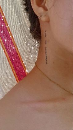 a close up of a person with a tattoo on their neck and behind her ear