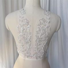 Description: Floral Leaf bodice lace applique with sequins, Silver Beads Embroidery Rhinestones Bridal lace applique, Beading butterfly applique for wedding dress, flower girl dress, Ear clip design ◆Size of the  applique: 13'' * 5.1'' ( 33 cm * 13  cm ) ◆Application:  Sew On patch ◆ These are lovely for decorating your dress, boutique accessories, doggies, craft, hat, bag, any sewing etc... For more quantity, please feel free to convo me for custom listing Thank you for stopping by my store.  ♡ Fitted Embellished Lace For Wedding, Fitted Pearl Embroidered Lace For Party, Fitted Wedding Lace With Sequins, Fitted Embellished Party Lace, Fitted Sleeveless Sequin Wedding Fabric, Fitted Sleeveless Sequin Fabric For Wedding, Beaded Lace Sequin Fabric For Wedding, Wedding Sequin Lace Fabric With Appliques, Fitted Lace Sequin Fabric For Wedding