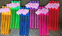 several different colored plastic straws with tags on them sitting next to eachother