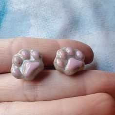 Adorable, handmade clay cat paw stud earrings. 🐈 The hypoallergenic studs were baked into the earring back to reduce irritation from metal. The earrings are on the larger size for studs, so please take that into consideration when ordering. :) I covered the front of the paw in resin, to give a nice shine and more durability. I painted the tiny toe bean beds. ❤️ Perfect gift for a cat lover! No returns accepted at this time, please message with any issues. Specially crafted for adult-sized ears, Clay Cat, Toe Beans, Cat Paw, Handmade Clay, Cat Paws, Earring Backs, Last Minute Gifts, Jewelry Earrings Studs, Cat Lover