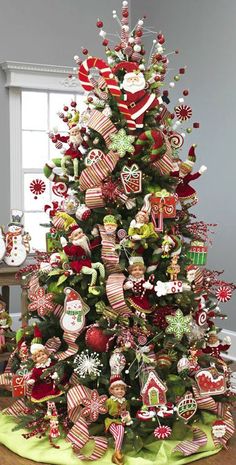 a christmas tree decorated with red and green ornaments, candy canes and gingerbread cookies