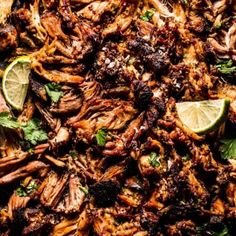 an overhead shot of meat with cilantro and limes