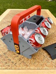 a picnic table with cans of soda and a shovel