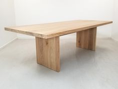 a wooden table sitting on top of a white floor