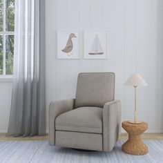 a living room with a chair, lamp and pictures on the wall