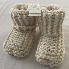 Sherpa Lined Softness Inside These Knit Booties For Knocking Around The House Cozy Knitted Booties With Round Toe, Comfortable Cream Winter Booties, Comfortable Warm Booties With Round Toe, Warm Comfortable Booties With Round Toe, Casual Warm Booties With Round Toe, Cozy Hand Knitted Round Toe Booties, Casual Hand Knitted Round Toe Booties, Cozy Cream Winter Booties, Warm White Winter Booties