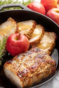 some meat and apples are in a pan