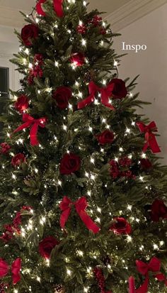 a christmas tree with red bows and lights