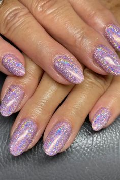 These nails feature a stunning purple glitter base that captures a holographic sparkle, reflecting a spectrum of colors under the light. The almond shape adds elegance, while the uniform glitter design across all the nails ensures a cohesive, glamorous look. Perfect for a night out or any festive occasion!  // Photo Credit: Instagram @krystlenailsandbeauty Purple And Sparkle Nails, Pink Sparkle Nails, Light Purple Nails, Holographic Glitter Nails, Oval Shaped Nails, Hoco Nails, Purple Glitter Nails, Glitter French Tips, Concert Ideas