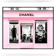 a pink store front with mannequins and chanel advertisement on the window