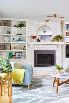 a living room filled with furniture and a fire place in the middle of a room