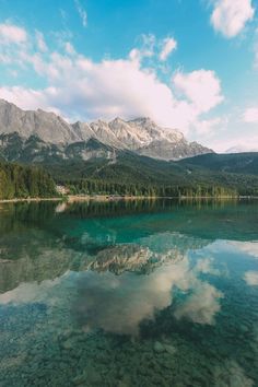 clear water with mountains in the background